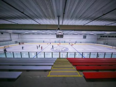 One of the ice rinks at New England Sports Village in Attleborough, MA.  The complex is dedicated to nurturing well rounded athletes. Spanning over 110,000 sq. ft., this state of the art ice facility includes two NHL size rinks, a 3/4 studio rink, and a dedicated goalie pad. Ongoing development includes a field house and a hotel. This sports complex aims to support traditional sports like soccer, lacrosse, field hockey, baseball, and gymnastics   alongside various recreational and dining amenities.  The complex also includes a full service athletic strength and conditioning center managed by Athletic Performance Training (APT), a physical therapy practice by Performance Physical Therapy, a family entertainment center, catering spaces, a restaurant called The Barn, and a Blue Line Cafe.