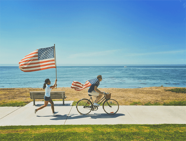 A graphic image of a gentleman riding a bicycle   symbolizing a journey with efforts   and wearing the American flag like the Superman dress hints at how EB 5 can make an investor feel triumphant.  With little or no backlogs in the category, EB 5 remains to be one of the favored options to settle in the US. The child following the man  represents the next generation of the immigrants who have settled through the EB 5 qualifying investment.  The child symbolizes assimilation and hope for the future.